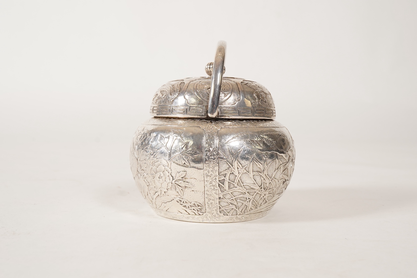 A Japanese Meiji period white metal tea caddy and cover with fluted knop, signed